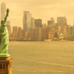 Humid day in New York City shows Statue of Liberty and skyline.