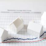 Four pieces of 3D models of houses over an investment chart.