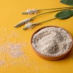 Psyllium plant product in a plate on yellow background.