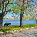 Two people sitting on a bench by the Charles Rives Esplanade in Boston, Massachusetts.