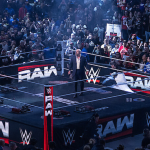 Audiences gathered and cheering around the wrestling ring for 'WWE Raw'