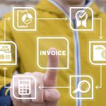 The word "invoice" being pressed by a businessperson in a virtual illustration of using an accounting software.