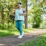 A senior black woman enjoying a morning run in a park.