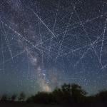 Long-exposure taken over 30 seconds showing many satellites moving across the night sky appearing as dotted lines.