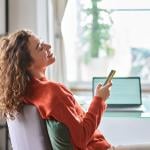 Young woman happily relaxing during a break at work showing a positive work-life balance.