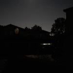 A suburban street in San Ramon, California is entirely dark except for a garage illuminated by a battery powered lantern during the Pacific Gas and Electric Public Safety Power Shutoff in 2019.