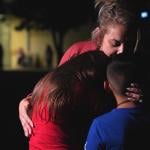 Families hug outside the Willie de Leon Civic Center where grief counseling is offered after a school shooting in Uvalde, Texas.