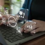 Continuous improvement concept illustrated by data icons superimposed over person typing on keyboard.