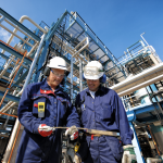 Two workers at an oil refinery plant