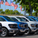 A row of Ford F-150 trucks for sale at a car dealership