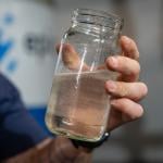 The director of water re-use operations for startup Epic Cleantec holds up a sample of treated water.