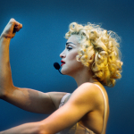 Madonna performing on stage during the Blonde Ambition tour, wearing a Jean Paul Goltier conical bra corset