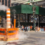 A steam pipe vent and scaffolding on the streets of New York City