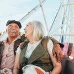 Cheerful senior couple enjoying a ferris wheel by the Santa Monica pier.