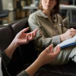 A counseling session showing the therapist in discussion with her client.