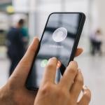 Person holding their phone with an incoming call from an unknown number.