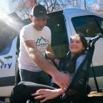 LJ Wilde, owner of Huckleberry Hiking, straps his daughter Luci into the hiking cart that he designed.