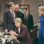 Charles Kimbrough, Joe Regalbuto, Grant Shaud, and Candice Bergen watch Faith Ford with a cat in a scene from “Murphy Brown,” 1990s.
