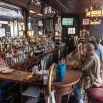 Patrons sitting at bar counter at the White Horse Tavern in New York City.