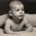 Small baby lying prone position, circa 1950s.