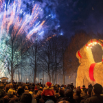 People look at fireworks during the inauguration of the traditional Gävle Goat Goat in Gävle Goat, Sweden during Christmas. 