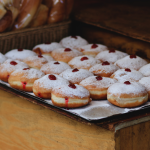 A baking tray full of freshly made sufganiyot