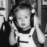 Baby in 1991 wearing headphones during an auditory test.
