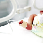 A baby in an incubator.