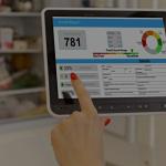 The image shows a person holding a tablet that displays a credit report, with a credit score of 781. The screen also contains details about credit card usage, bank accounts, and credit history.