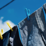 Blue jeans hanging on an outdoor clothes line.