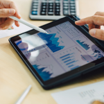 Two business colleagues analyzing company finances on a tablet.