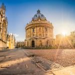 Radcliffe square with the Science Library and sunset flare in Oxford, England.