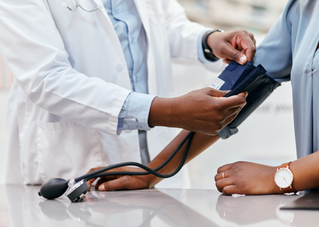 A primary care doctor checking a patient's blood pressure.