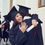 A girl hugging someone after graduating and receiving her diploma