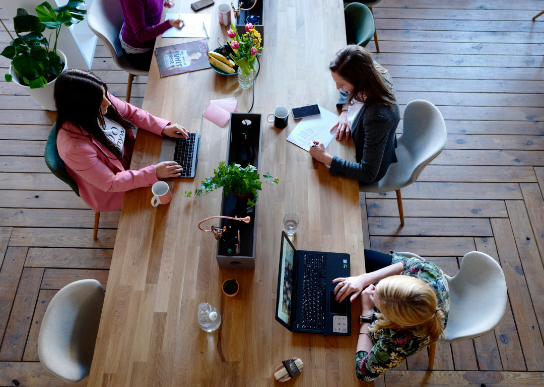 Threee office workers in a coworking space.