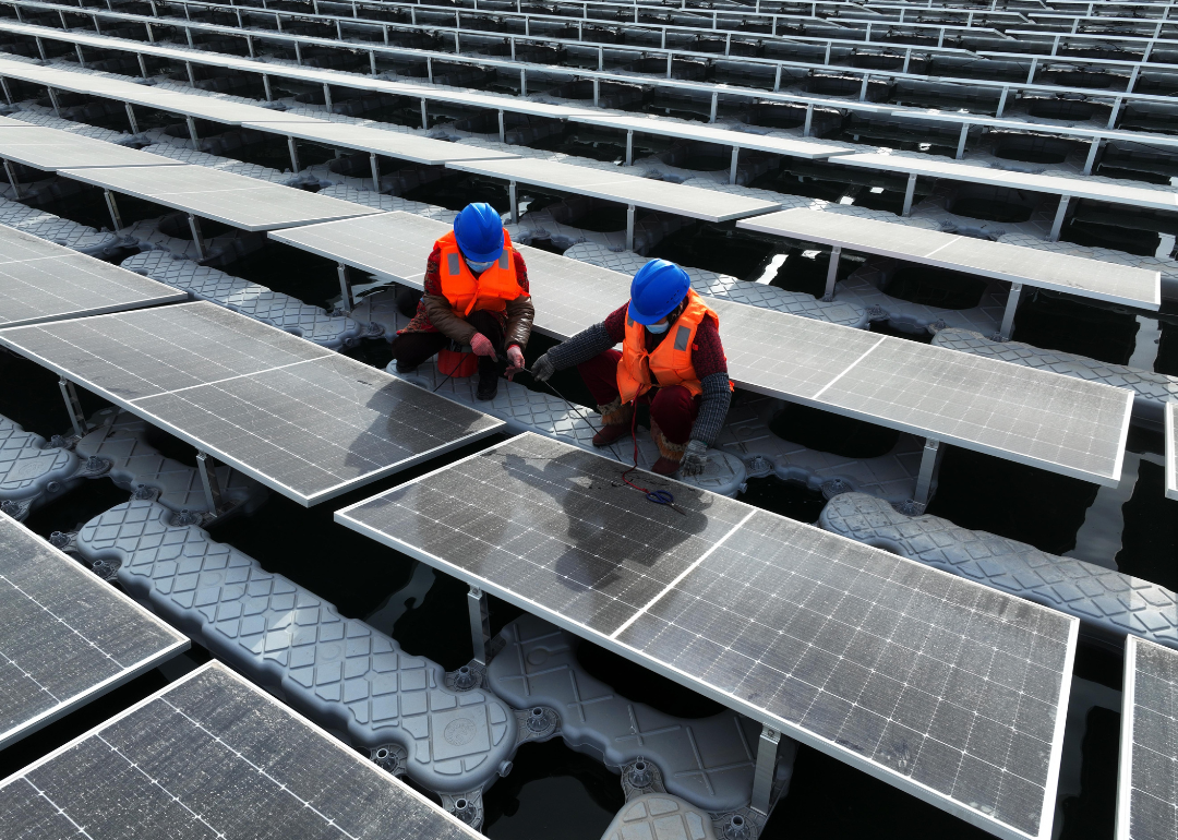 Aerial view of workers installing solar panels.