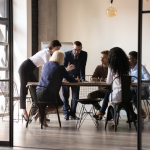 A team of employees meeting in a modern boardroom.