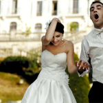 A couple at their wedding looking happy.