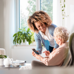 A nurse helping a woman in an assisted living facility.