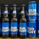 Bottles and cans of Bud Light on display on a store shelf