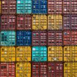 Stacks of different colored shipping containers.