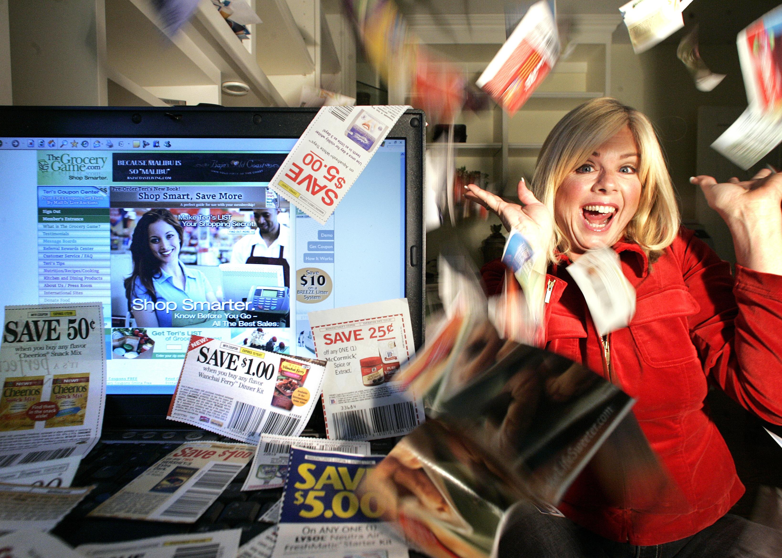 A woman throws coupons in the air next to a computer showing digital coupons.