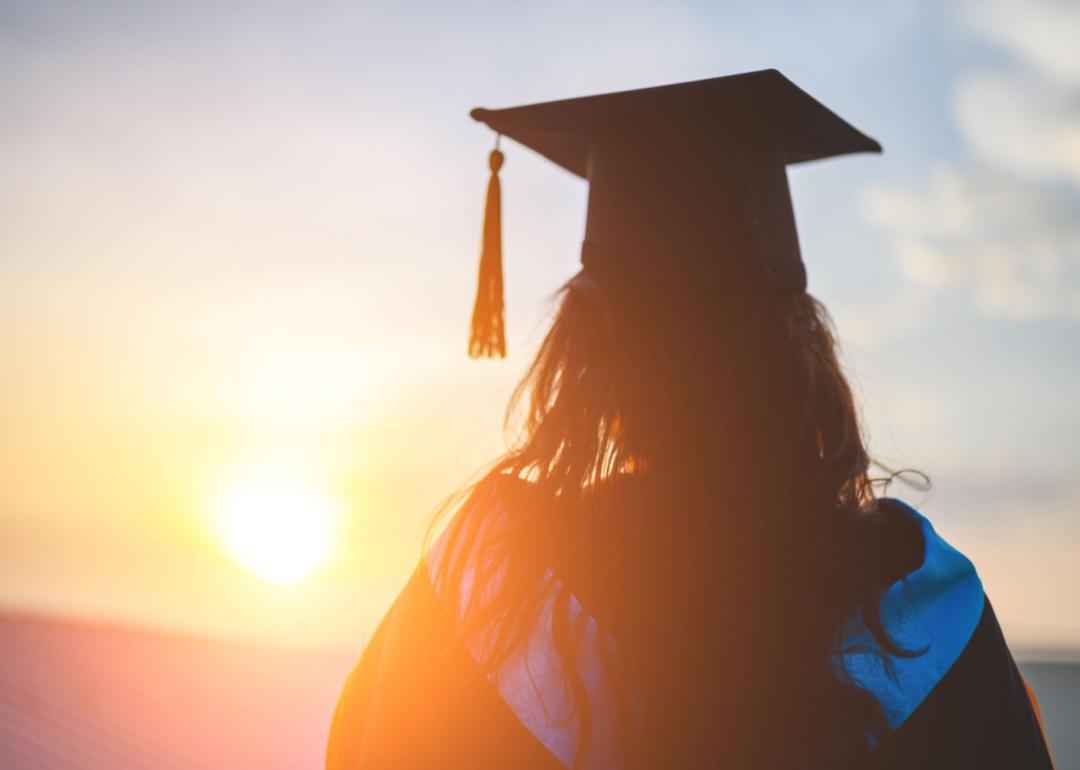 A graduate looking at the sunset.