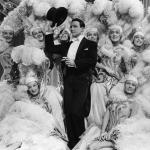 Gene Kelly with dancers in costume in musical romantic comedy film 'Singin' in the Rain'.