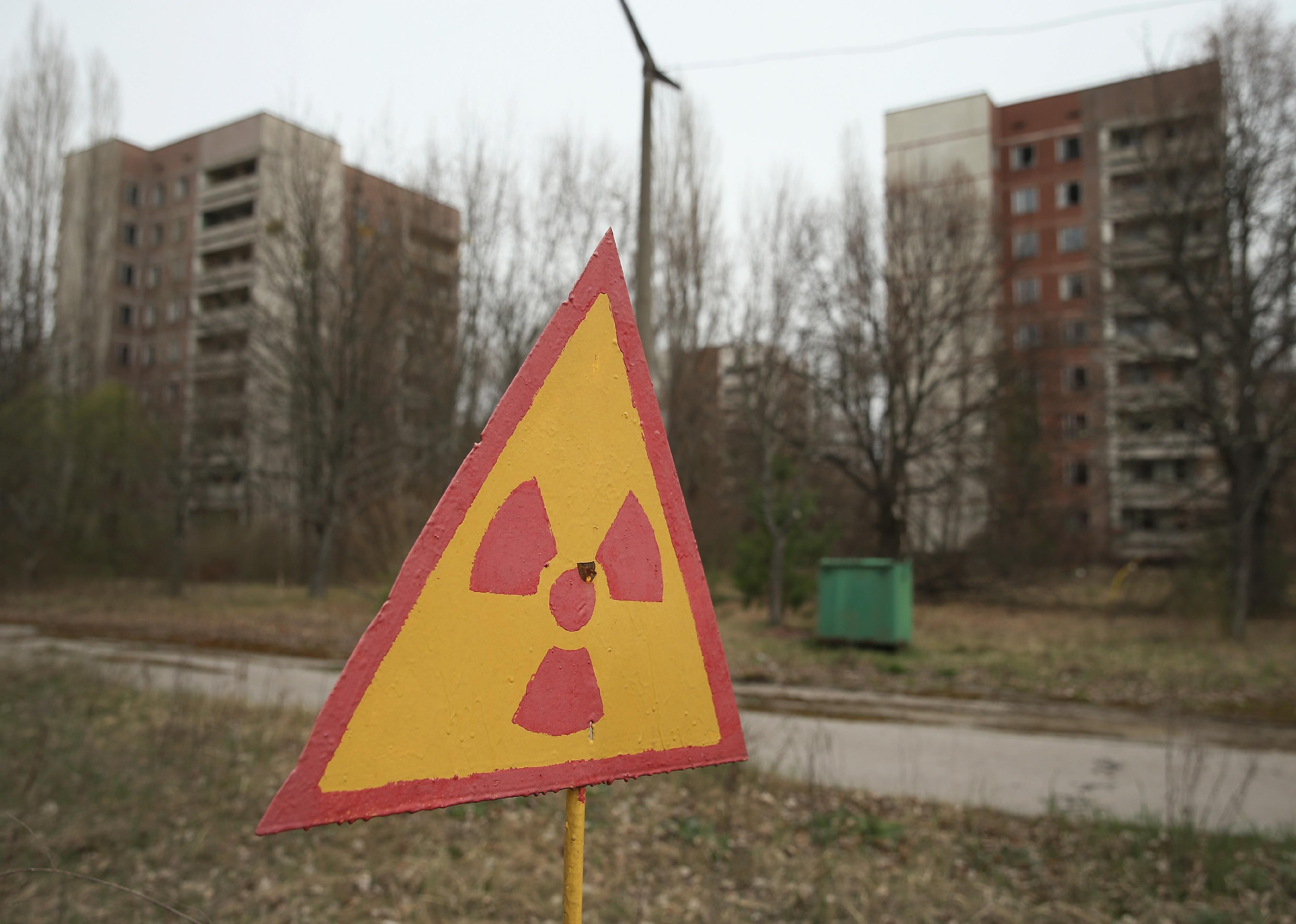 A sign warns of radiation contamination near former apartment buildings.