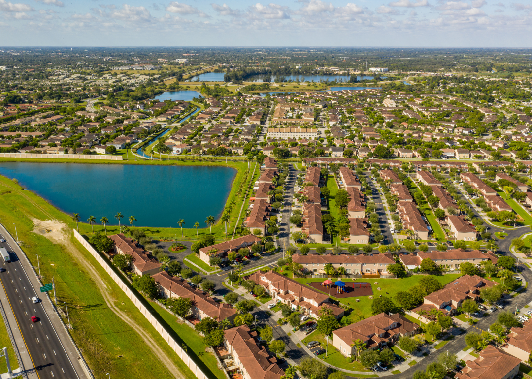 An aerial view of Florida homes near water and surrounded by palm trees.