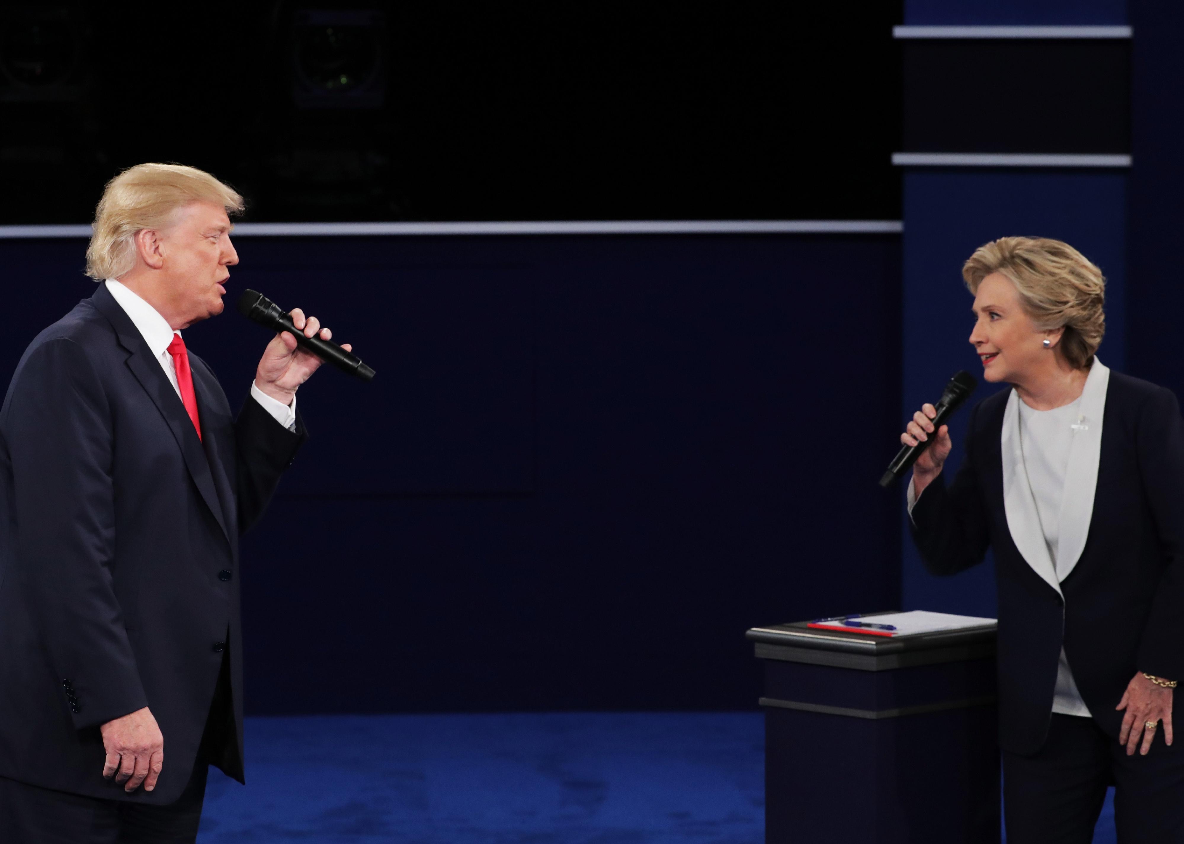 Donald Trump and Hillary Clinton speak during a debate onstage.