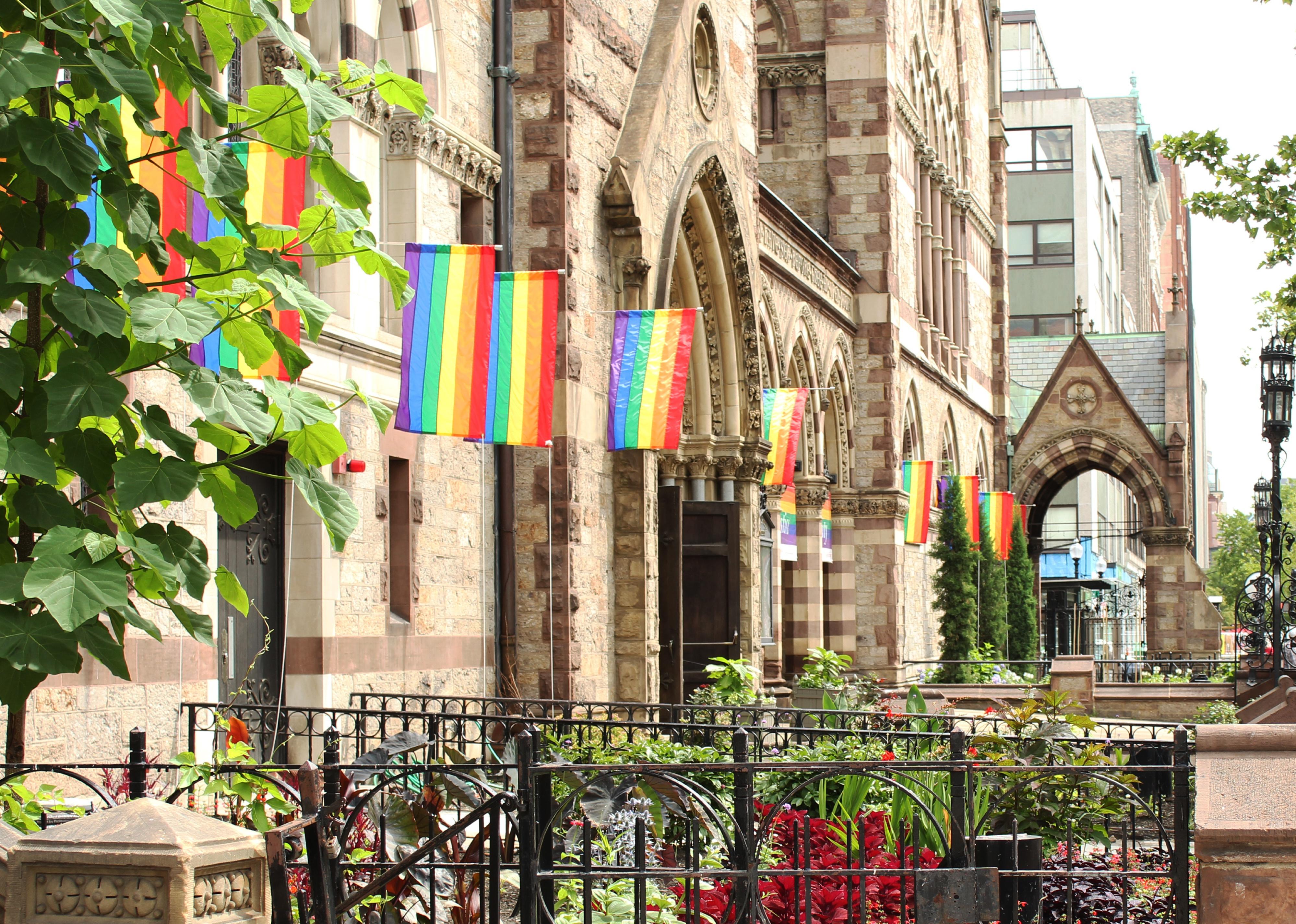 Pride flags on church building in city
