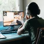 Teenager playing Counter Strike Global Offensive video game on PC.