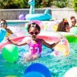 Little girl on pool inflatable.